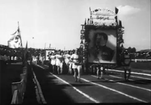 Sportininkų kolona neša Stalino portretą. Epizodas iš 1946 m. dokumentinio filmo ,,Tarybų Lietuva“